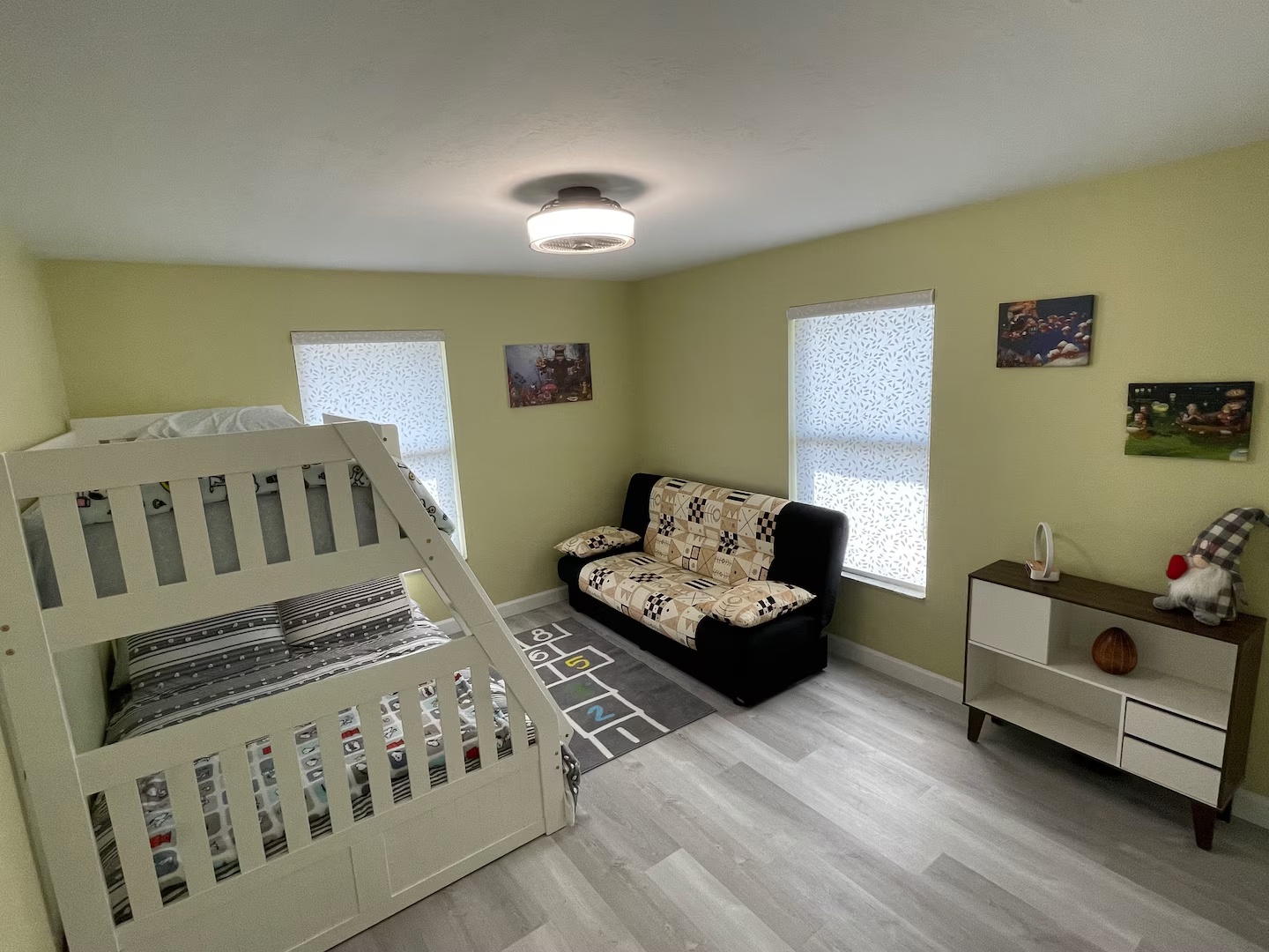 Family-friendly bedroom with bunk bed and sofa