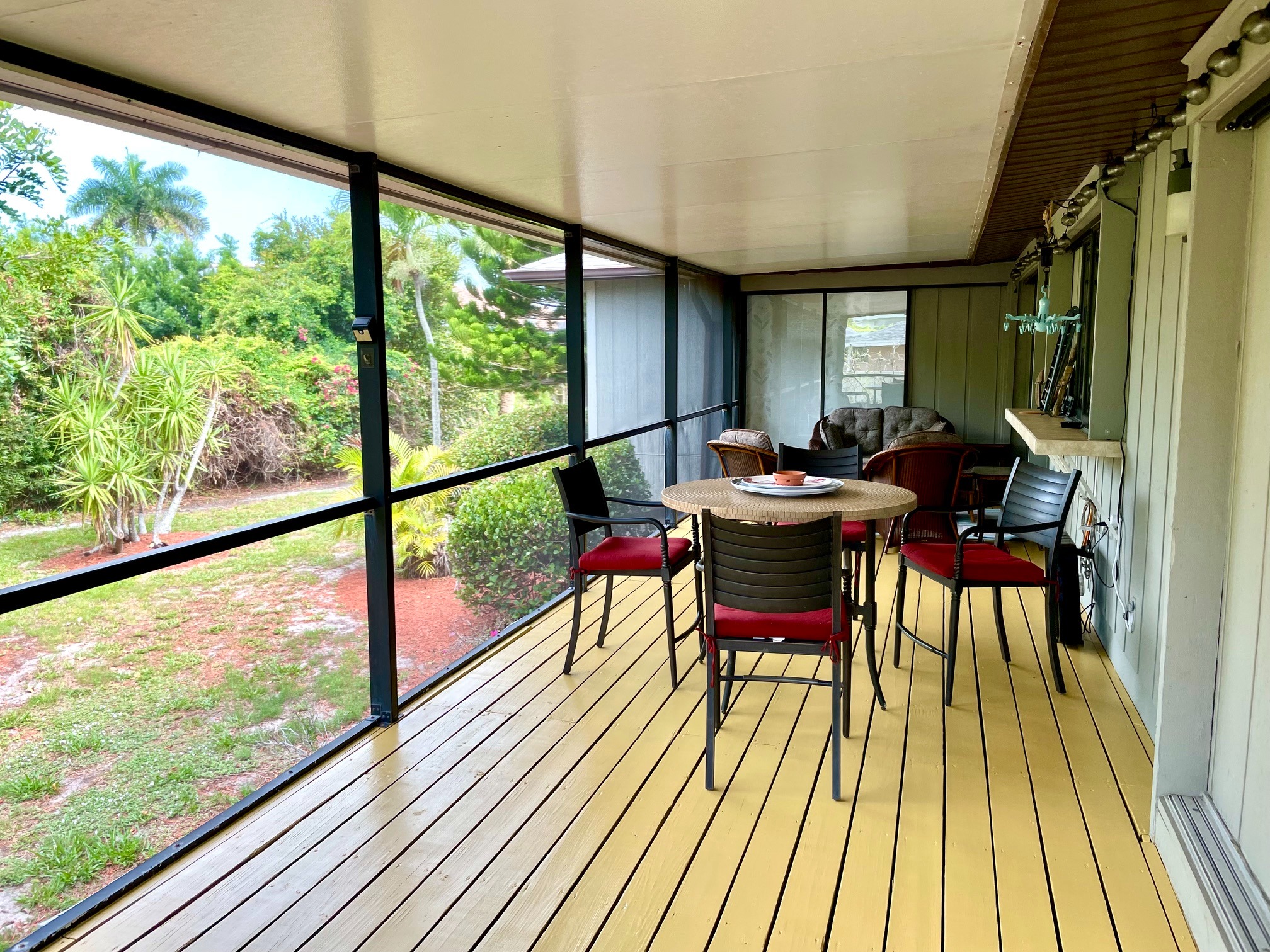 Screened lanai overlooking tropical landscaping